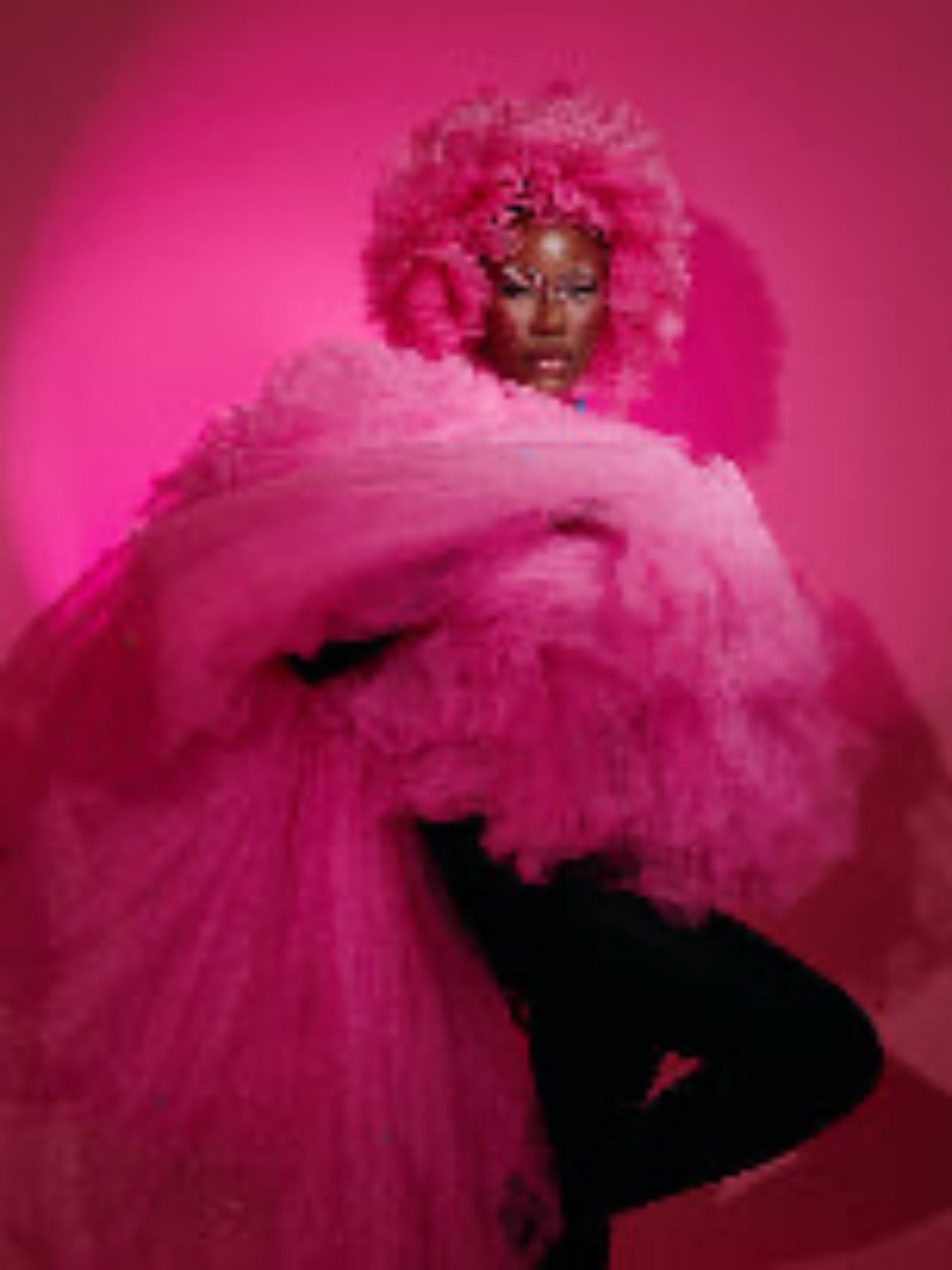 Person in a vibrant pink tulle dress by dimazbrand against a pink background